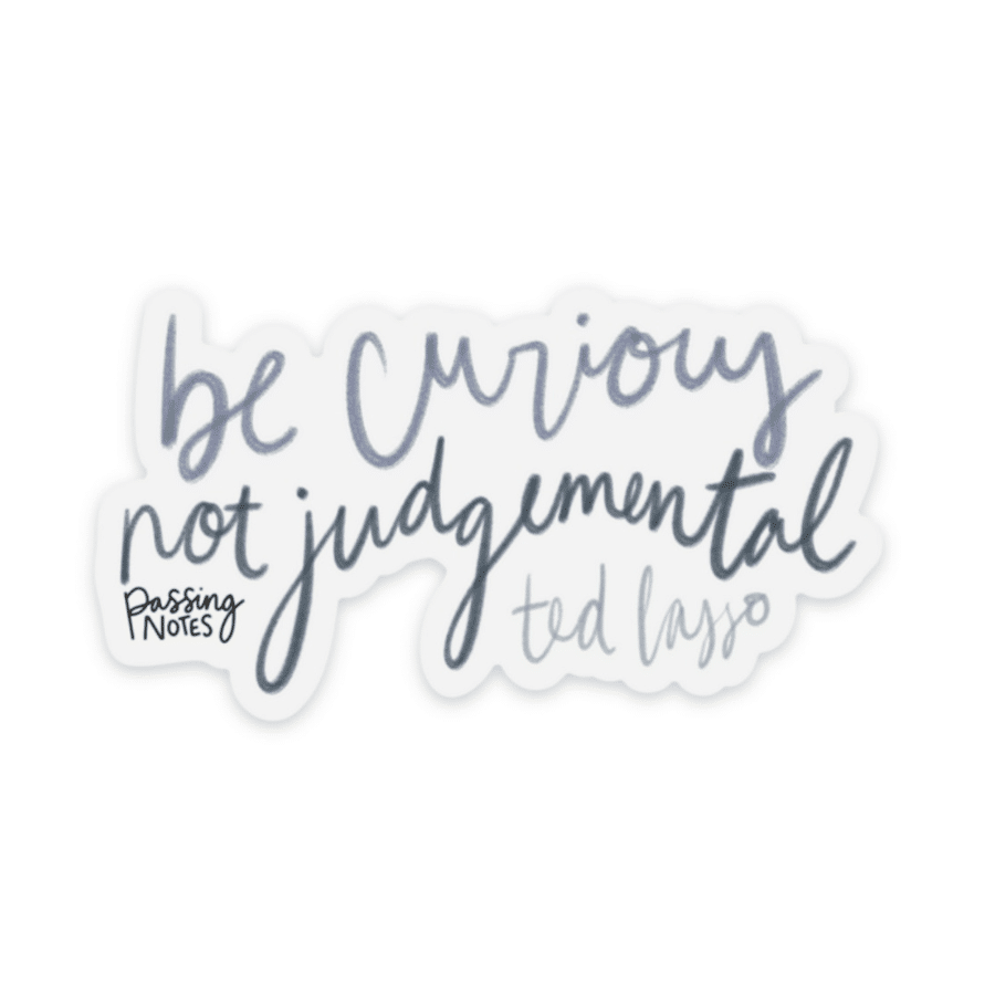 Clear backed stickers that says "be curious not judgemental" by ted lasso, in varied medium blue handwritten fonts