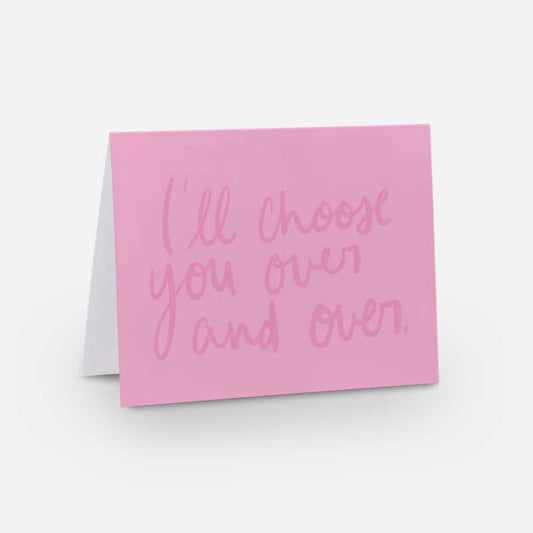 A2 horizontal sized card with a pink background and a dark pink handwritten font that says "I'll choose you over and over"