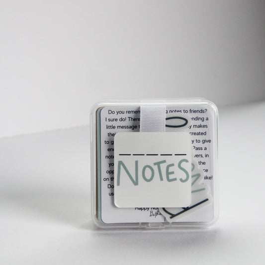 A small clear plastic case with a white square label reading "Fill in the Blank Notes" in a playful font. The box contains 40 durable note cards that include encouraging  prompts that you can fill out and pass on to others for a boost of  appreciation and encouragement!