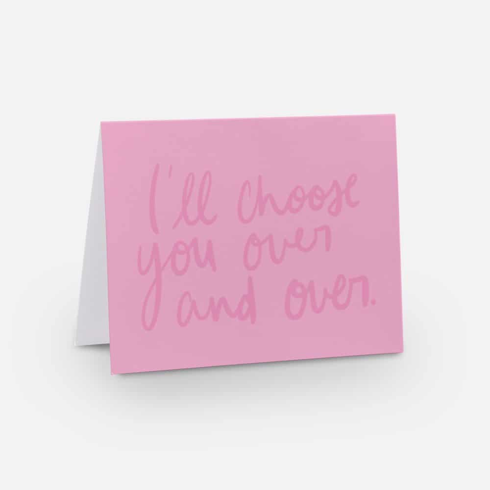 An I love you card with a pink background and a dark pink handwritten font that says "I'll choose you over and over"