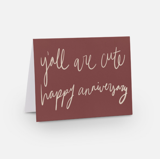 A2 horizontal sized card with a wine red background with cream handwritten font that says "y'all are cute happy anniversary"