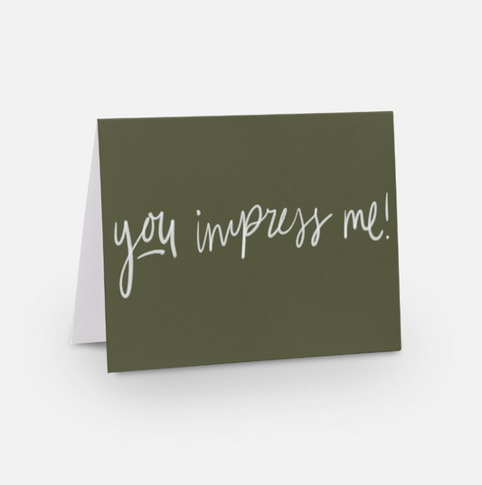 A2 horizontal sized card with olive green background and white handwritten font that says "you impress me!"